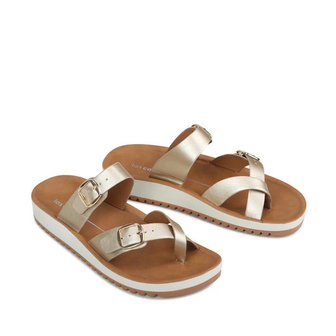 The Los Cabos Nins Champagne Adjustable Womens Summer Sandal features tan soles, white midsoles, and metallic gold vegan leather straps with adjustable buckles, shown on a white background., 46984, 9321191226729, 9321191226736, 9321191226743, 932119122675
