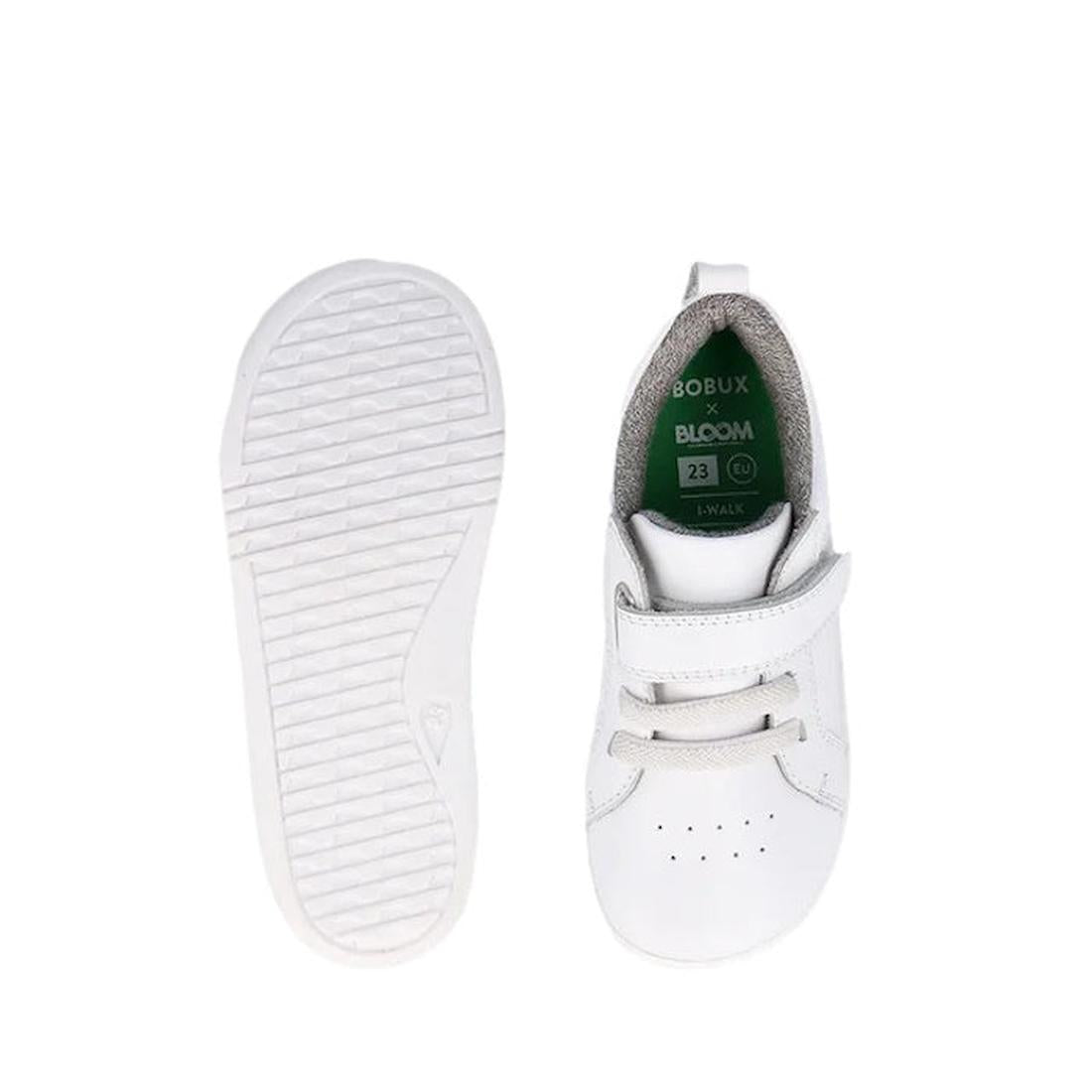 The Bobux Kids IWalk IW Pace Optical White Sneaker is pictured from the top, showing perforated details and green insoles, and from the bottom, revealing a textured grip pattern on the sole. Suitable for all kids with an easy Velcro closure., 47909, 94200
