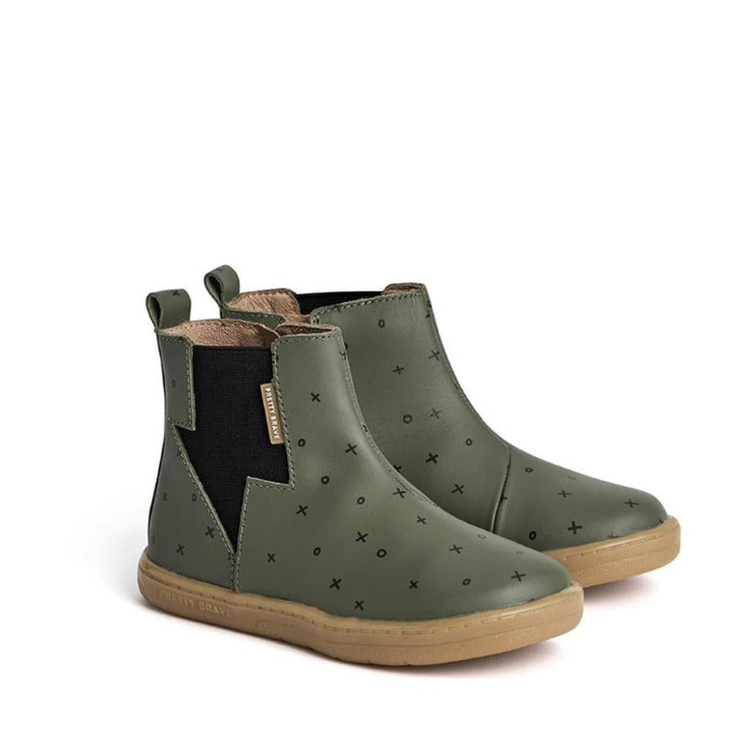 The Pretty Brave Electric Boot Khaki XO are kids’ olive green ankle boots with black elastic panels, pull tabs, tan rubber soles, and a small black X pattern—stylish leather boots for comfort and play., 28805, 28806, 9420075305335, 9420075305342, 94200753