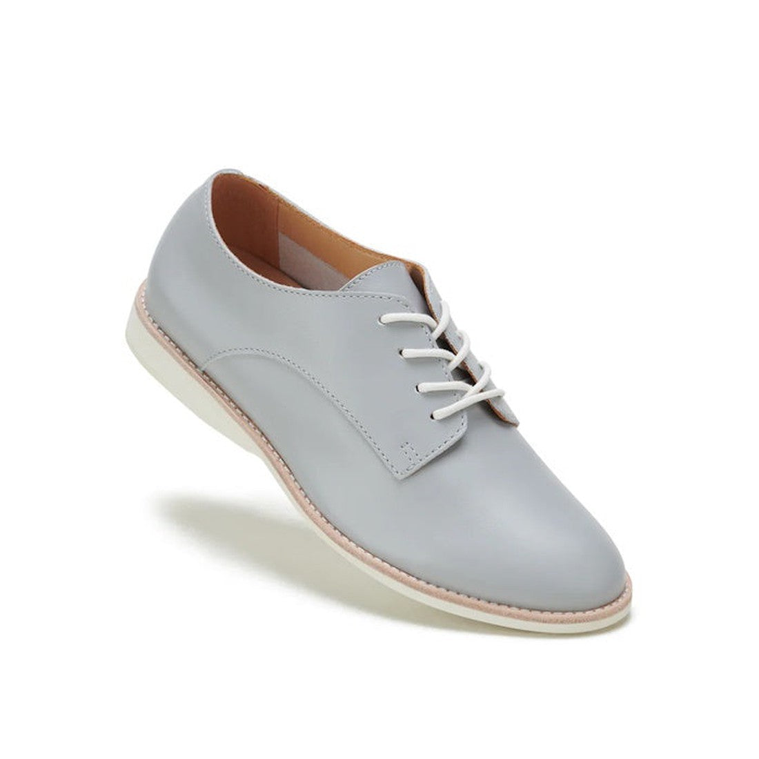 The Rollie Womens Derby Super Soft Stone Leather Shoe features premium light gray leather, white laces, a beige interior, and a white sole for sneaker-like comfort, shown against a plain white background.