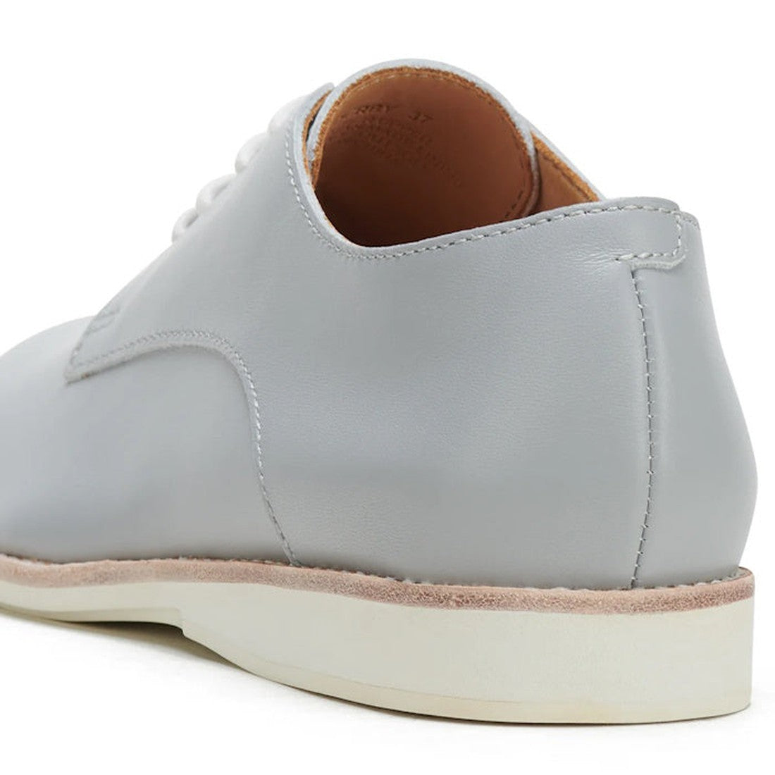 A close-up of the Rollie Womens Derby Super Soft Stone Leather Shoe, featuring light gray premium leather, beige stitching, a white sole, and sneaker-like comfort, showcased from the back and side on a white background., 9781760763930, 9781760763947, 9781