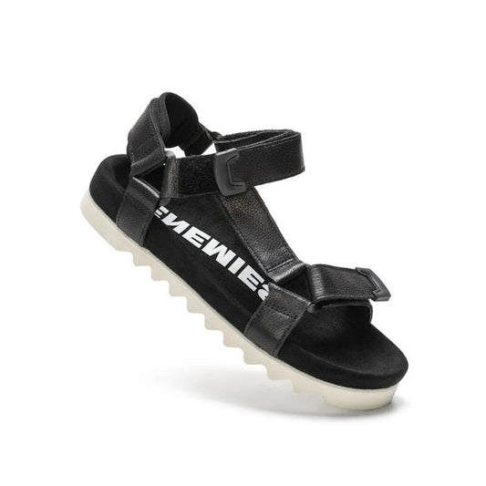 The Rollie Womens Sandal Tooth Wedge Black features adjustable black sheep leather straps, a white jagged EVA sawtooth outsole, and bold white EMEWIE text on the side.