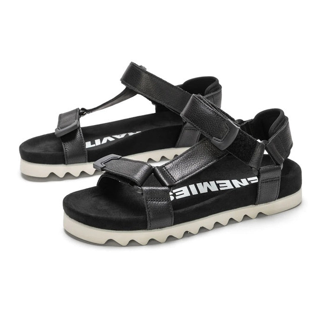 The Rollie Womens Sandal Tooth Wedge Black features adjustable black sheep leather straps, white jagged EVA sawtooth soles, and ENEMIE branding in white on the black footbeds for comfort and style., 9339554310381, 9339554310398, 9339554310404, 93395543104