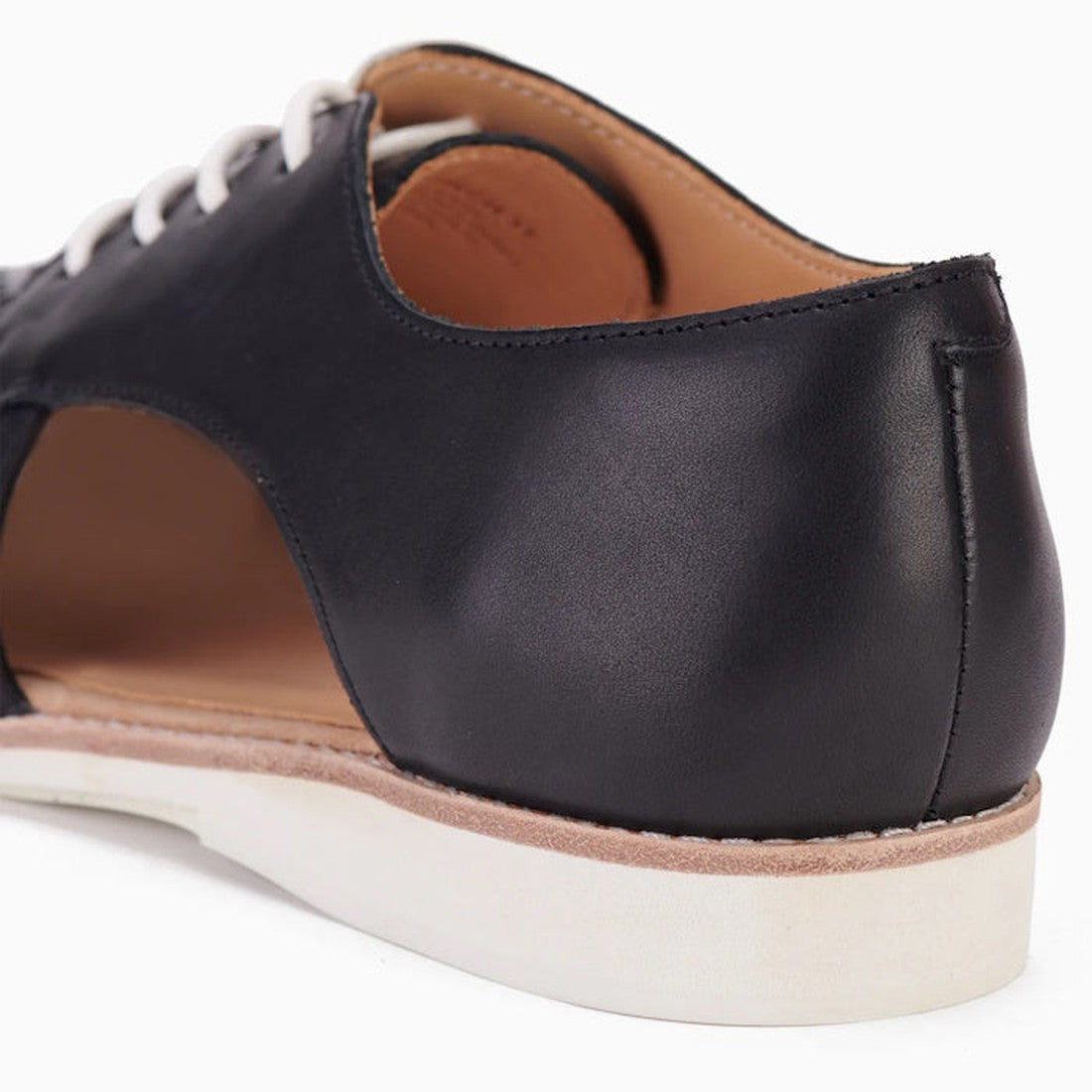 Close-up of the Rollie Womens Sidecut Punch Black Leather Shoe, showing black leather with white laces, tan interior, white rubber sole, cut-out heel design for breathability, and cushy EVA midsoles for all-day comfort., 9339554249179, 9339554249186, 9339