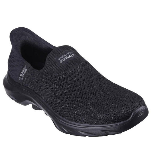 The Skechers Womens Slip In Go Walk 7 Springtime Black is a slip-on with a knitted mesh upper, cushioned sole, low heel, Air-Cooled Memory Foam for comfort, and Skechers logos on the top and side.