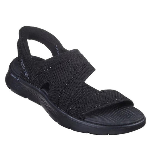 The Skechers Womens Slip Ins Sandals Go Walk Flex Belle Black features a black open-toe vegan design, two wide crisscross fabric straps, textured sole, and offers comfort and style for casual wear.