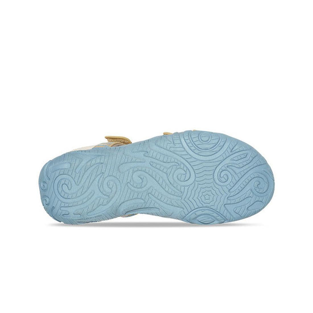 The Teva Girls Active Sandal K Tirra STACKS COCOON is shown from the bottom, featuring a light blue rubber sole with an intricate swirl pattern—ideal for vegan footwear with quick-dry webbing, set against a plain white background., 195719341305, 195719341