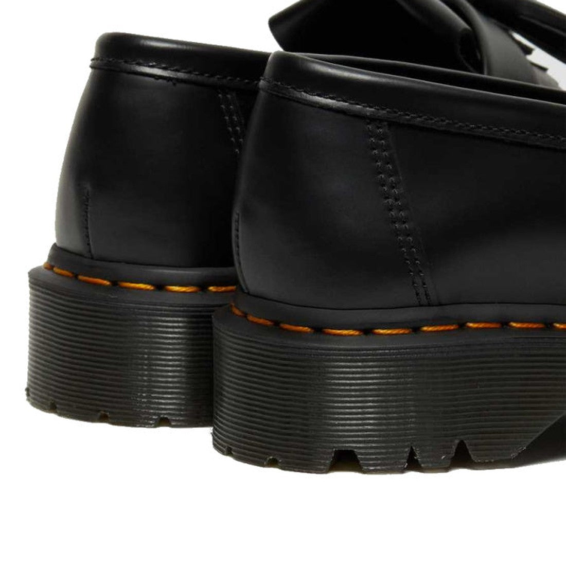 Close-up of the back and heels of two Dr Martens Adrian Bex Black Smooth Platform Loafer Shoes, featuring thick grooved soles and signature yellow stitching on the base., 183681, 190665420241, 190665420166, 190665420173, 190665420180, 190665420197, 190665