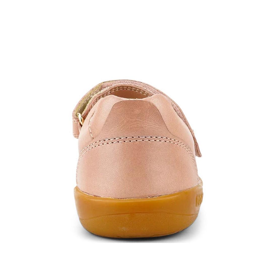 A close-up rear view of the Bobux Kid+ Delight Mary Jane Dusk Pink 831625Z shows its light pink finish, tan rubber sole, visible heel, stitching, and strap details against a plain white background., 9420075719187, 9420075719194, 9420075719200, 94200757192