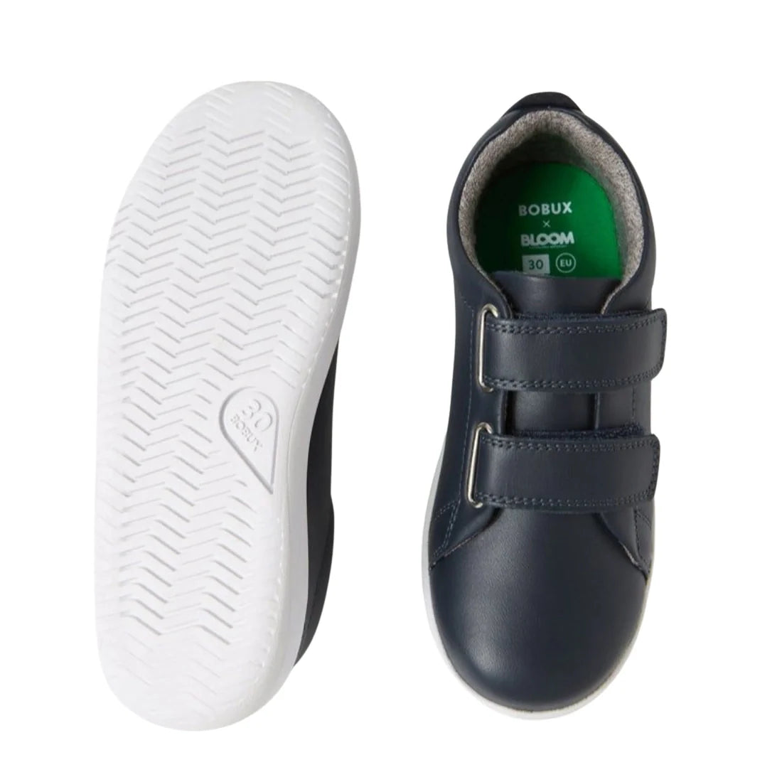 The Bobux KP Kids Plus Grass Court 2 II Leather Sneaker in navy features white soles, adjustable straps, and a green insole printed with BOBUX x BLOOM and size 30. Shown from the side and bottom., 9420074831255, 9420074831262, 9420074831279, 9420074831286