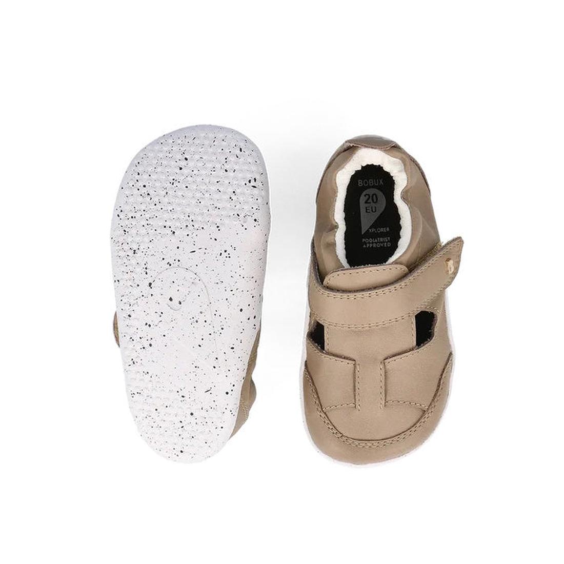 The Bobux XP Explorer Beau First Walker Sandal in Atmosphere (502301) is a light brown toddler shoe with a white speckled flexible sole and Velcro strap, shown from the top and bottom. Perfect for little ones learning to walk., 9420075784338, 942007578369