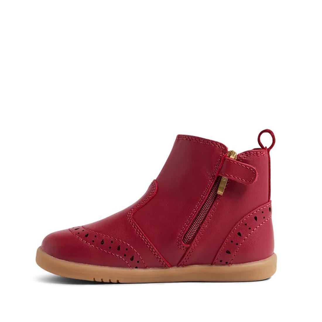 The Bobux Iwalk Billie Toddlers Leather Boot in Tibitan Red (652004) features red leather, a tan rubber sole, side zipper, pull tab, decorative perforations, and stitching—ideal for classic Billie boot fans. Shown on a plain white background., 94200685437