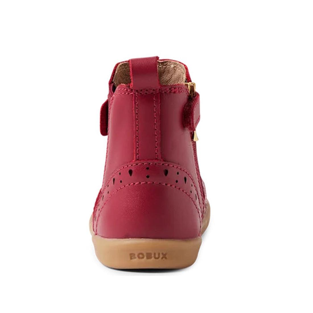 A rear view of the Bobux Iwalk Billie Toddlers Leather Boot in Tibitan Red, featuring red leather, decorative stitching, heart-shaped cutouts, tan rubber sole, and BOBUX embossed on the heel., 9420068543799,
9420068543805,
9420068543812,
9420068543829,
94