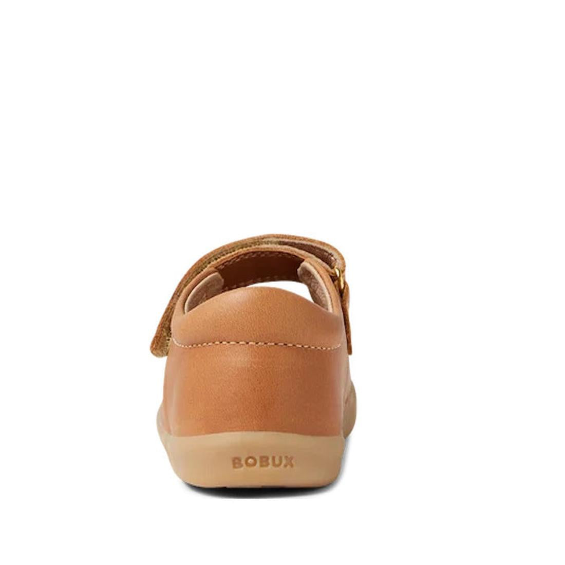 Rear view of the Bobux Iwalk Lola Toddlers Mary Jane in caramel tan leather, showing a beige flexible sole and BOBUX embossed on the heel. The shoe has a handy hook-and-loop strap for easy fastening., 9420068549531, 9420068549548, 9420068549555, 942006854