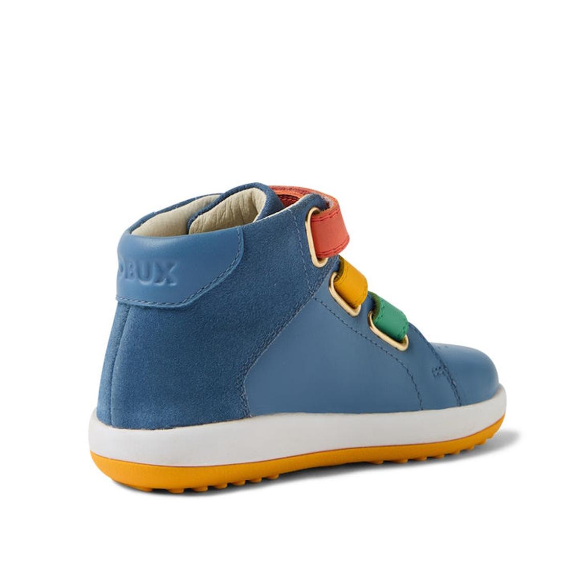 The Bobux IW Iwalk Gamepoint Leather Boot in Coronet Blue is a children’s high-top with a yellow sole, red/yellow/green hook-and-loop straps, anti-slip rubber outsole, and the brand name embossed on the heel. Seen from the back left side., 9420074815170, 