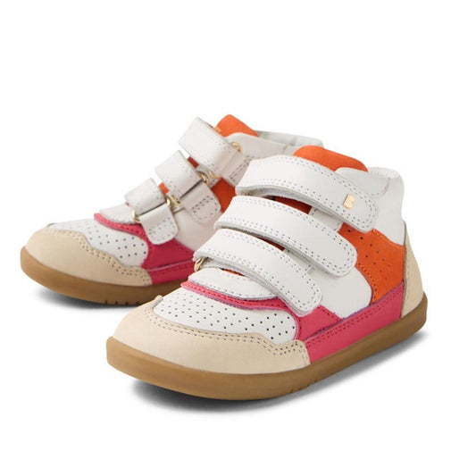 The Bobux IW Iwalk Harley Leather Boots Radiant Raspberry feature white uppers, pink and orange accents, beige toe caps, gum soles, and three adjustable straps—perfect for kids who want comfort and standout style.
