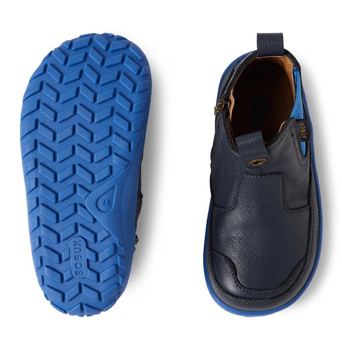 Two views of the Bobux IW Iwalk Trail Leather Boot Navy Alpha: The left shows the zigzag tread bright blue zero drop sole, while the right highlights the barefoot-shaped toe box, zip closure, and pull tab., 9420068563568, 9420068563575, 9420068563582, 942