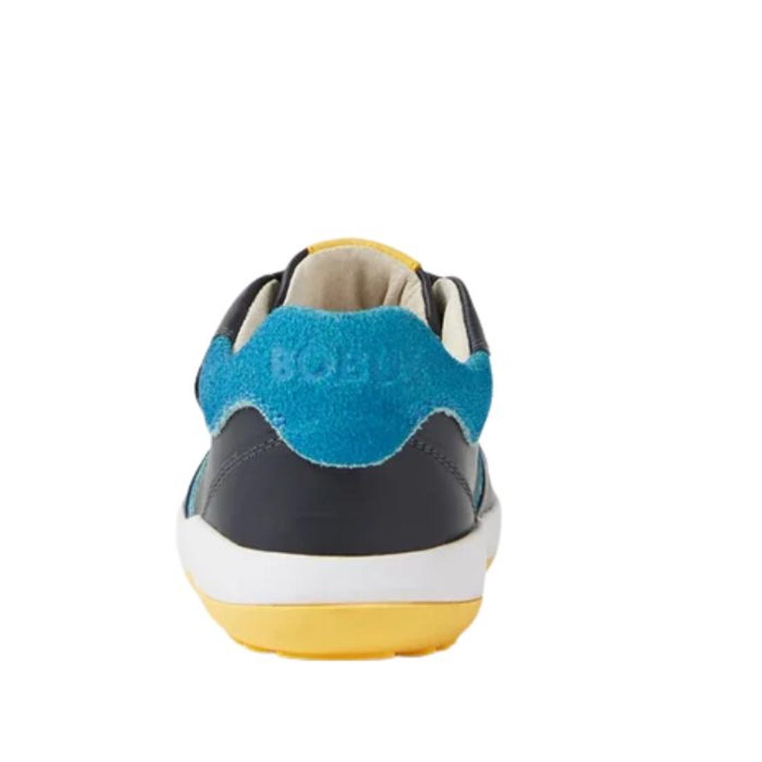 Rear view of the Bobux IW Iwalk Baseline Leather Mid Sneaker Navy, featuring kids' leather with a blue suede heel panel, dark upper, white midsole, and yellow outsole, photographed against a plain white background., 9420074818560, 9420074818577, 942007481