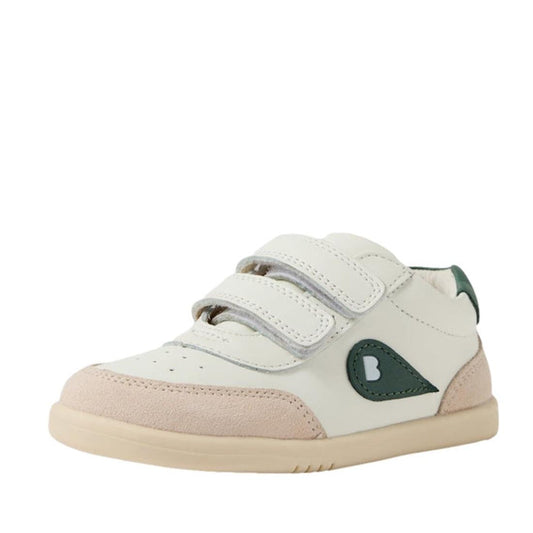 The Bobux Toddlers IWalk IW Champ II Sneaker in Chalk White and Rainforest Green is a white and beige leather toddler shoe with green accents, adjustable hook-and-loop straps, and a teardrop-shaped side design, shown on a white background.