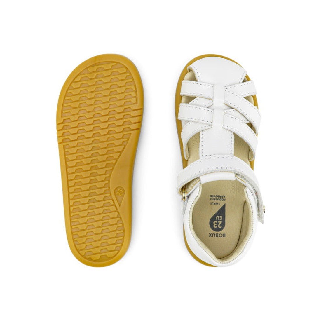 The Bobux iWalk Cross Jump Sandal White Closed Toe 636706 is shown in white leather with tan rubber soles; one sandal displays the textured sole, while the other highlights the strappy top and buckle design., 9420062083949, 9420062083956, 9420062083963, 9