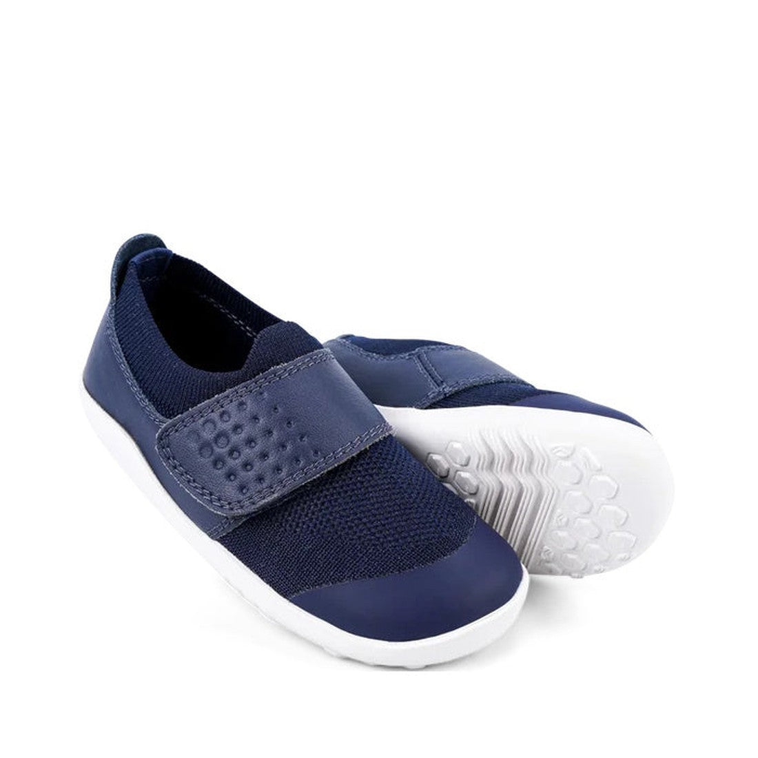 The Bobux Iwalk Lo Dimension III Blue Navy Trainer 638506 Unisex features navy uppers with a honeycomb pattern, white soles, and a textured Velcro strap. One shoe stands upright while the other is tilted to display the sole., 9420062025925, 9420071311699,
