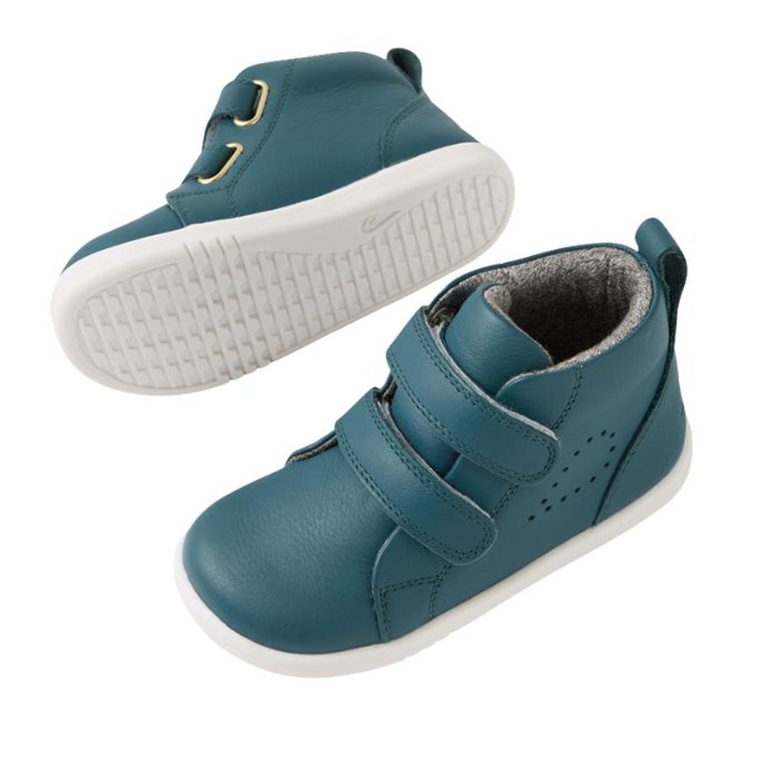 The Bobux IW Iwalk Grass Court Hi Leather Boot in Mediterranean Green for toddlers features a high-top style with white soles, two adjustable straps, gold eyelets, and a textured sole. One shoe is shown from the top/side, the other displays the sole., 942