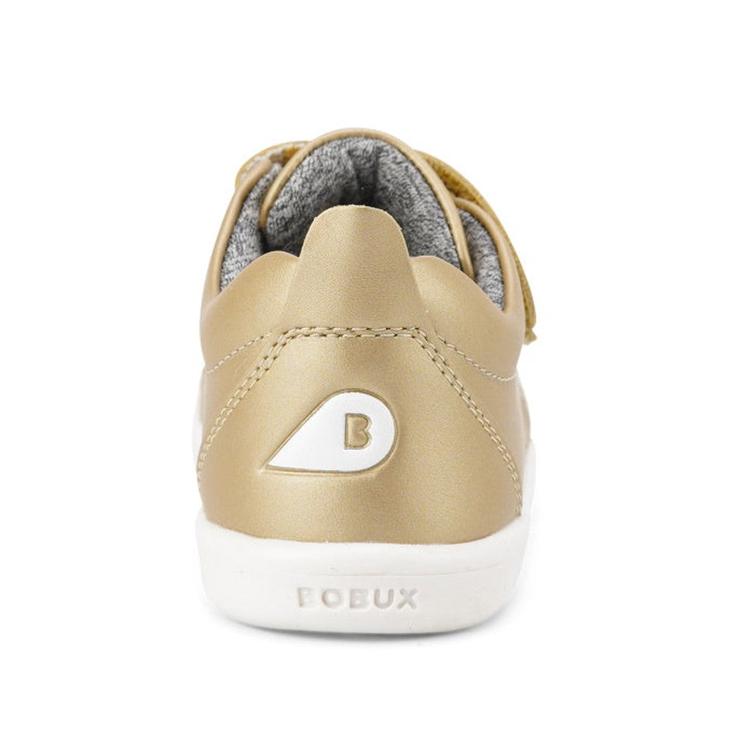A rear view of the Bobux Iwalk Grass Court Gold Leather Trainer shows a gold unisex kids' sneaker with a white sole, “B” logo on the heel, “BOBUX” embossed on the sole, and a soft padded lining for extra comfort., 9420071310470, 9420071310456, 94200713104
