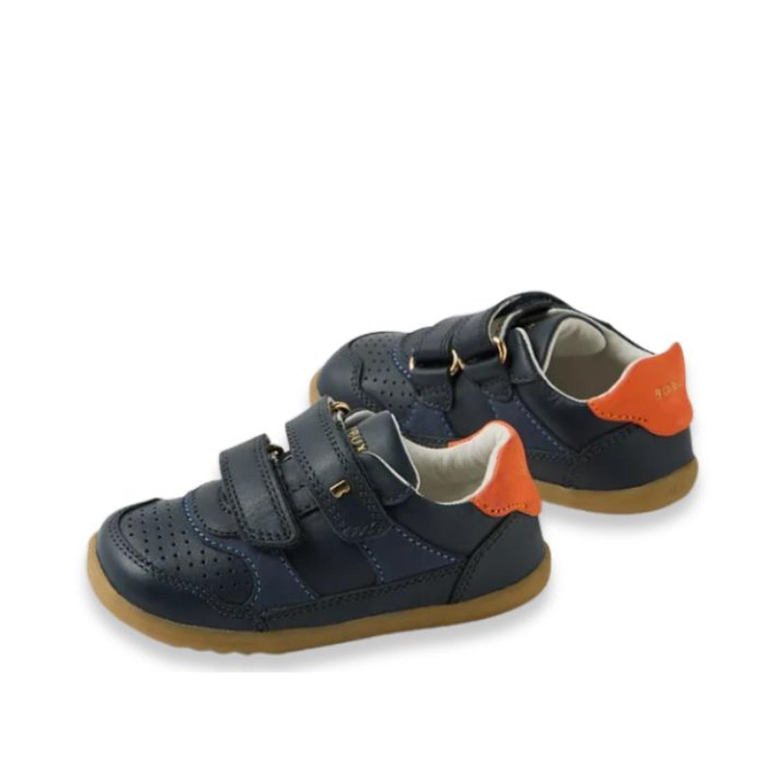 The Bobux IW Iwalk Hunter Leather Sneaker in navy for kids features tan soles, orange heel accents, perforated toe detailing, and two adjustable velcro straps, crafted from Quickdry leather and shown against a white background., 9420074834096, 94200748341