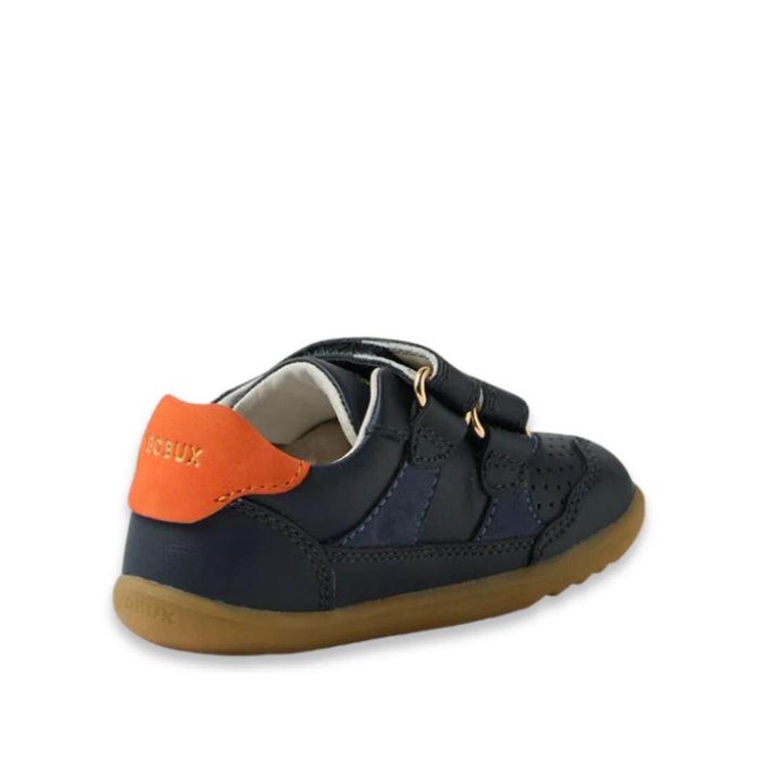 The Bobux IW Iwalk Hunter Leather Sneaker Navy is a kids' leather shoe featuring a brown sole, two adjustable straps, perforated details, and an orange heel accent. The side and back view shows the Bobux brand name on the heel tab., 9420074834096, 9420074