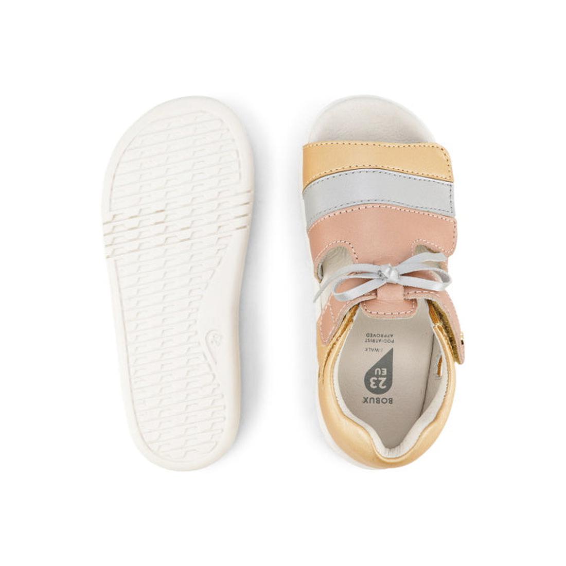 The Bobux IW Iwalk Mirror Pale Gold 633433 is a girls' open-toed sandal in pale gold leather with white soles and a velcro strap, shown with one shoe sole up and the other top view., 9420068524088, 9420068524095, 9420068524101, 9420068524118, 942006852412