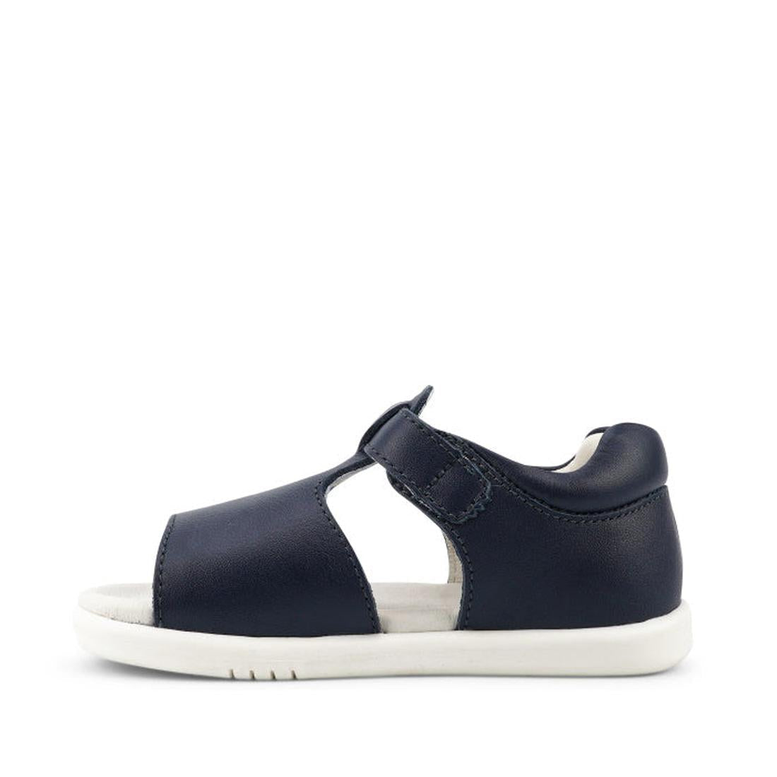The Bobux IW Iwalk Mirror Navy Kids Sandal 633429 is a navy blue leather toddler sandal with an open toe, white sole, side cutout, and adjustable strap, shown from the side on a plain white background., 9420068523746, 9420068523753, 9420068523760, 9420068