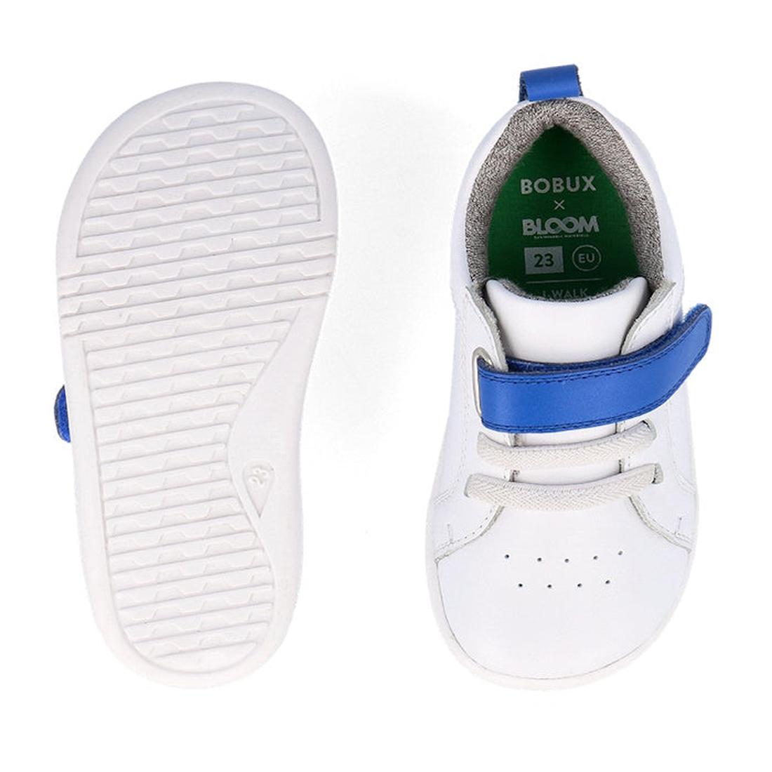 A pair of Bobux Kids IWalk IW Pace Sneaker White Blue 650401 are shown: one displays the insole with BOBUX x BLOOM branding and EU size 23, while the other shows the textured sole. Both feature blue straps on white leather., 9420075780583, 9420075779693, 