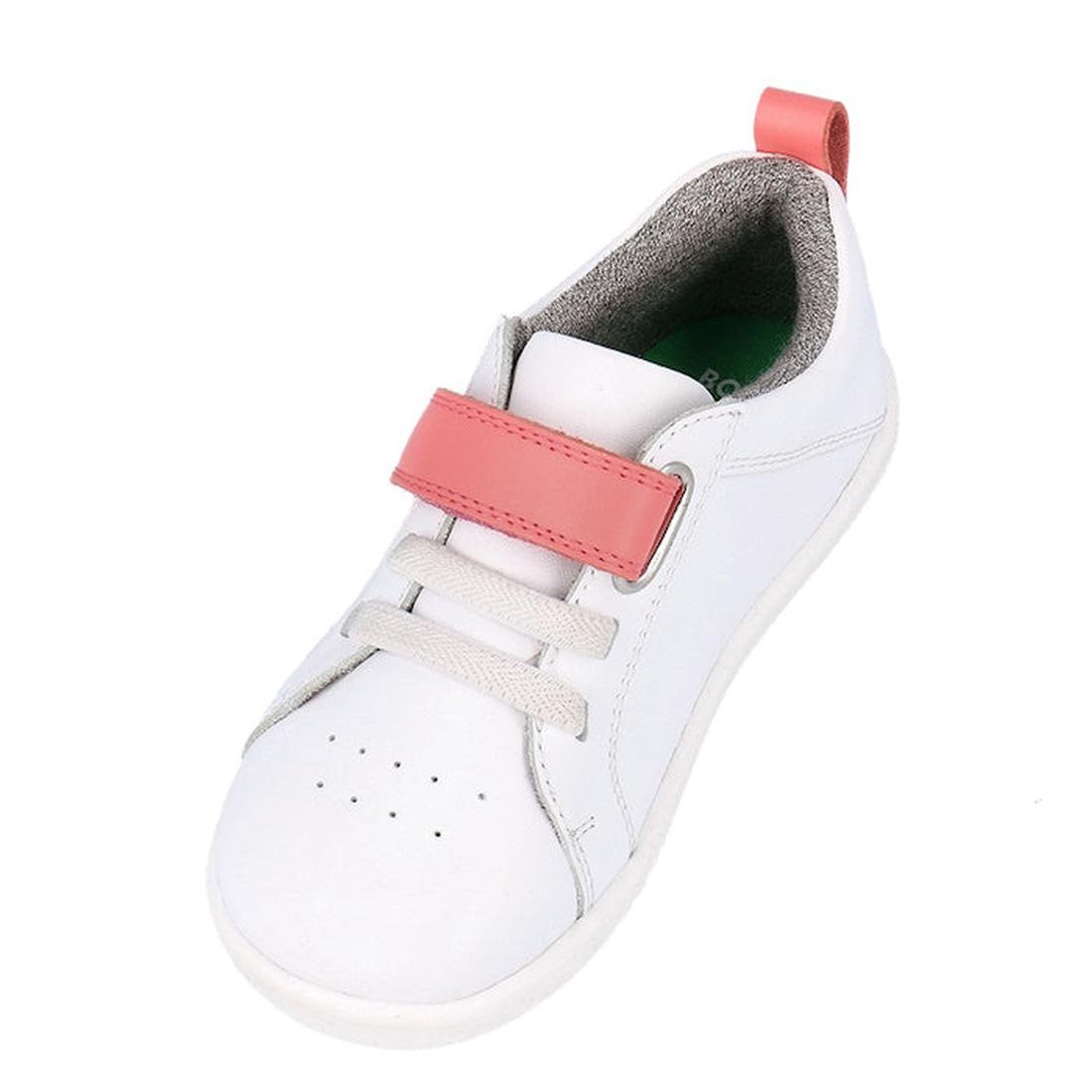 The Bobux Kids IWalk IW Pace Sneaker White Coral 650402 is a unisex kids’ leather sneaker in white with a pink velcro strap, white laces, grey lining, and a pink heel pull tab, shown angled against a white background., 9420075781894, 9420075779273, 942007