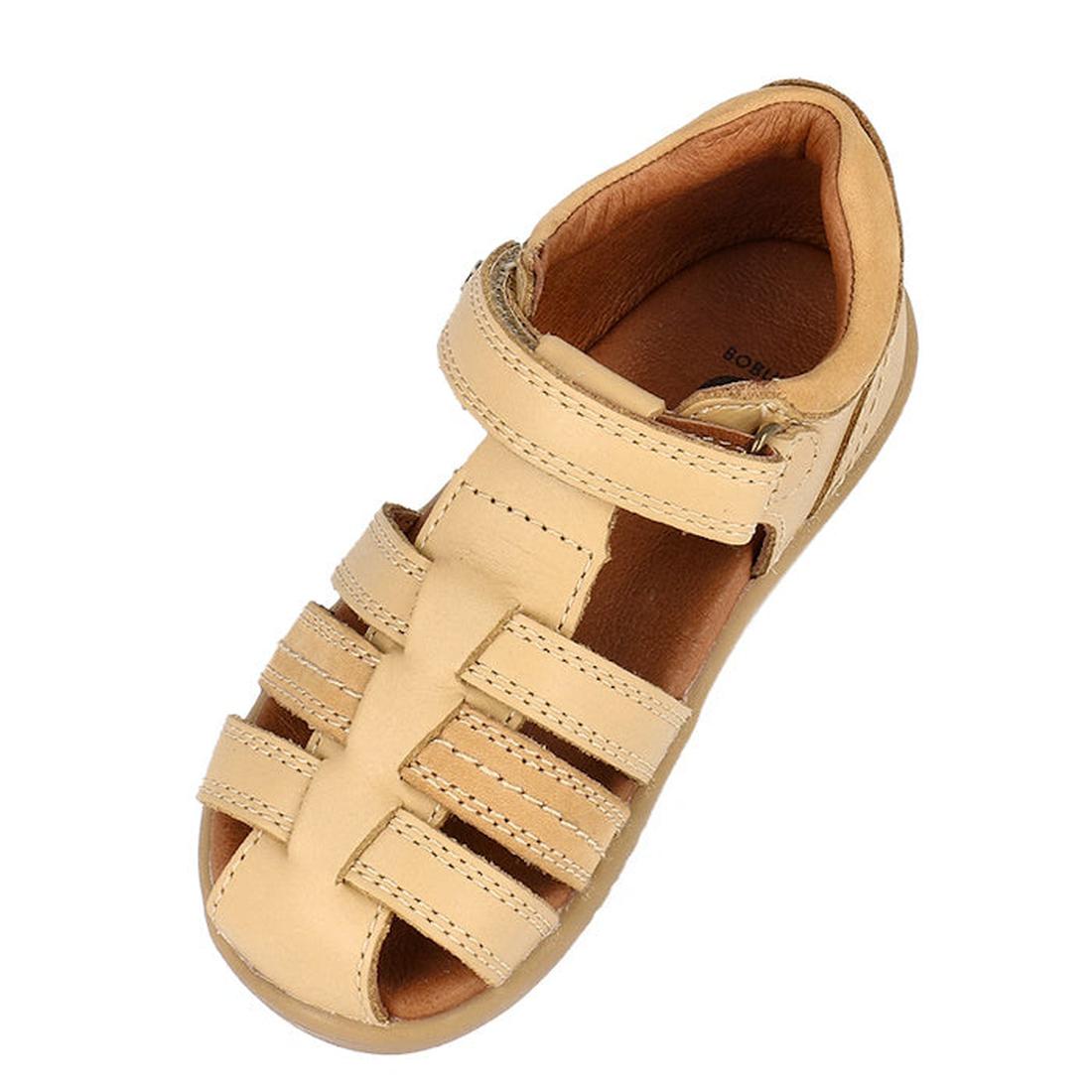 The Bobux IWalk Roam Sandal Parchment Beige Closed Toe 626030 is a tan toddler leather sandal with three front straps, open sides, a Velcro ankle strap, and visible stitching for comfort and durability., 9420075781610, 9420075782907, 9420075780408, 942007