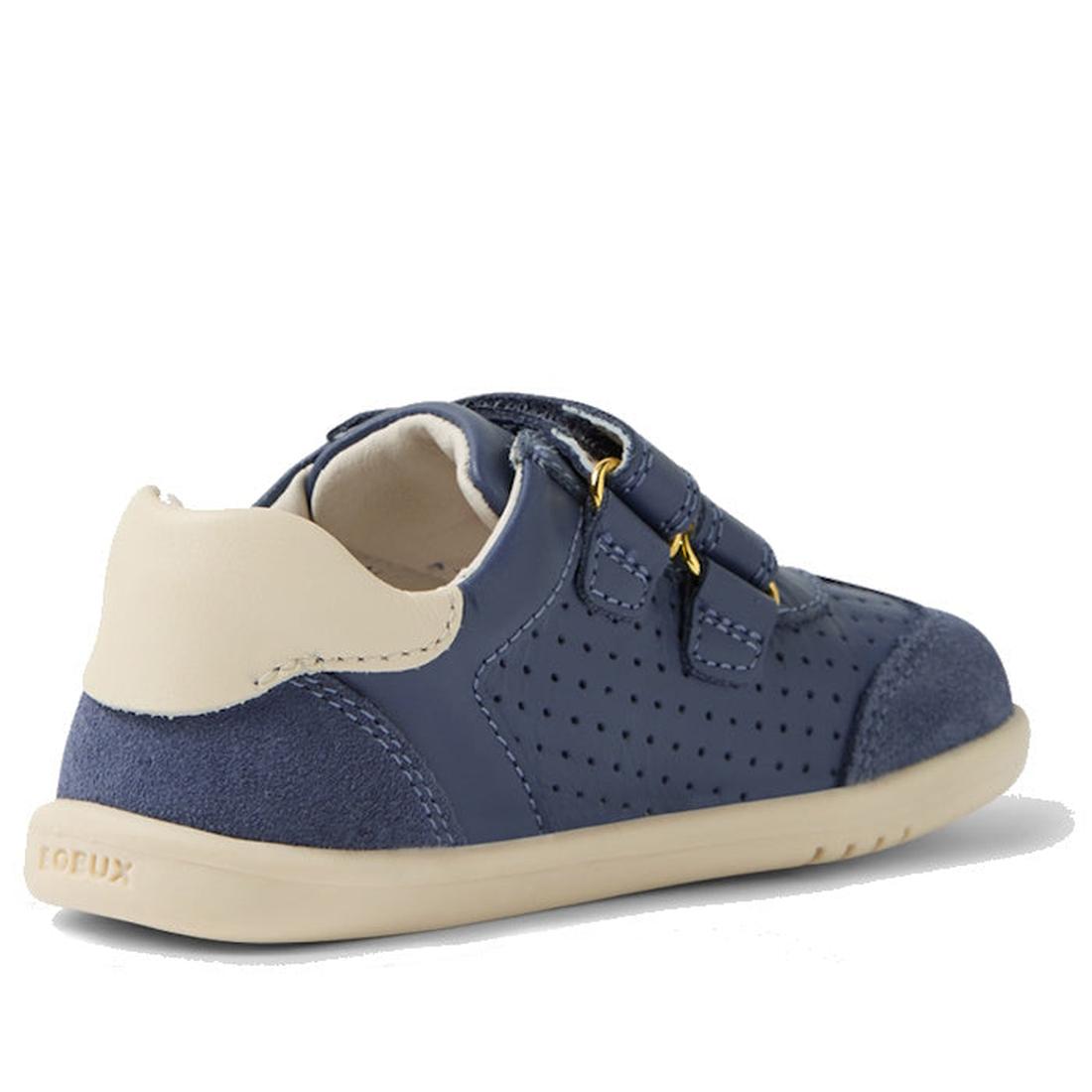 The Bobux IW Iwalk Titan Leather Sneaker in White Vintage Indigo Blue features Velcro straps, perforated detailing, and a flexible beige sole for toddlers. Shown from the back side angle and available in multiple sizes and colors., 9420074854292, 94200748