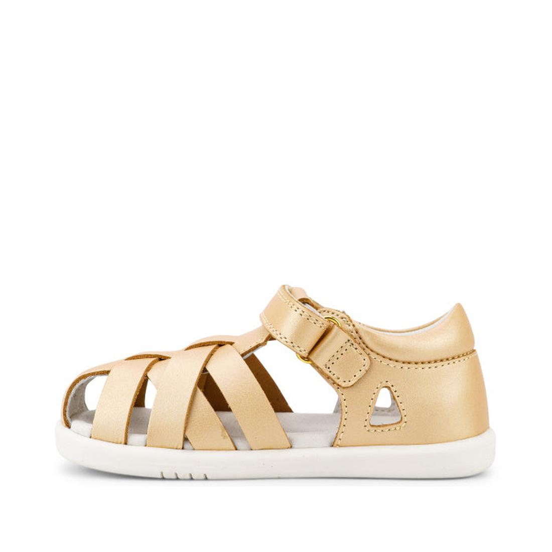 The Bobux Iwalk IW Tropicana II Sandal 638311 in Pale Gold is a closed-back, open-toe sandal with a white sole, multiple Quick Dry Leather straps, and an adjustable hook-and-loop ankle strap for secure fastening., 9420068529946, 9420068529953, 94200685299