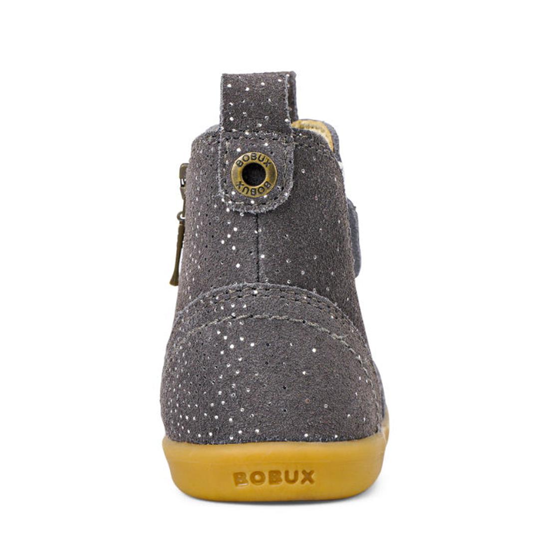 The Bobux Iwalk Jodhpur Boot Charcoal Starburst 620857 features gray suede leather with silver glitter, a tan rubber sole embossed with BOBUX on the heel, and a metal Bobux logo button near the top., 9420071309801, 9420071309818, 9420071309825, 9420071309