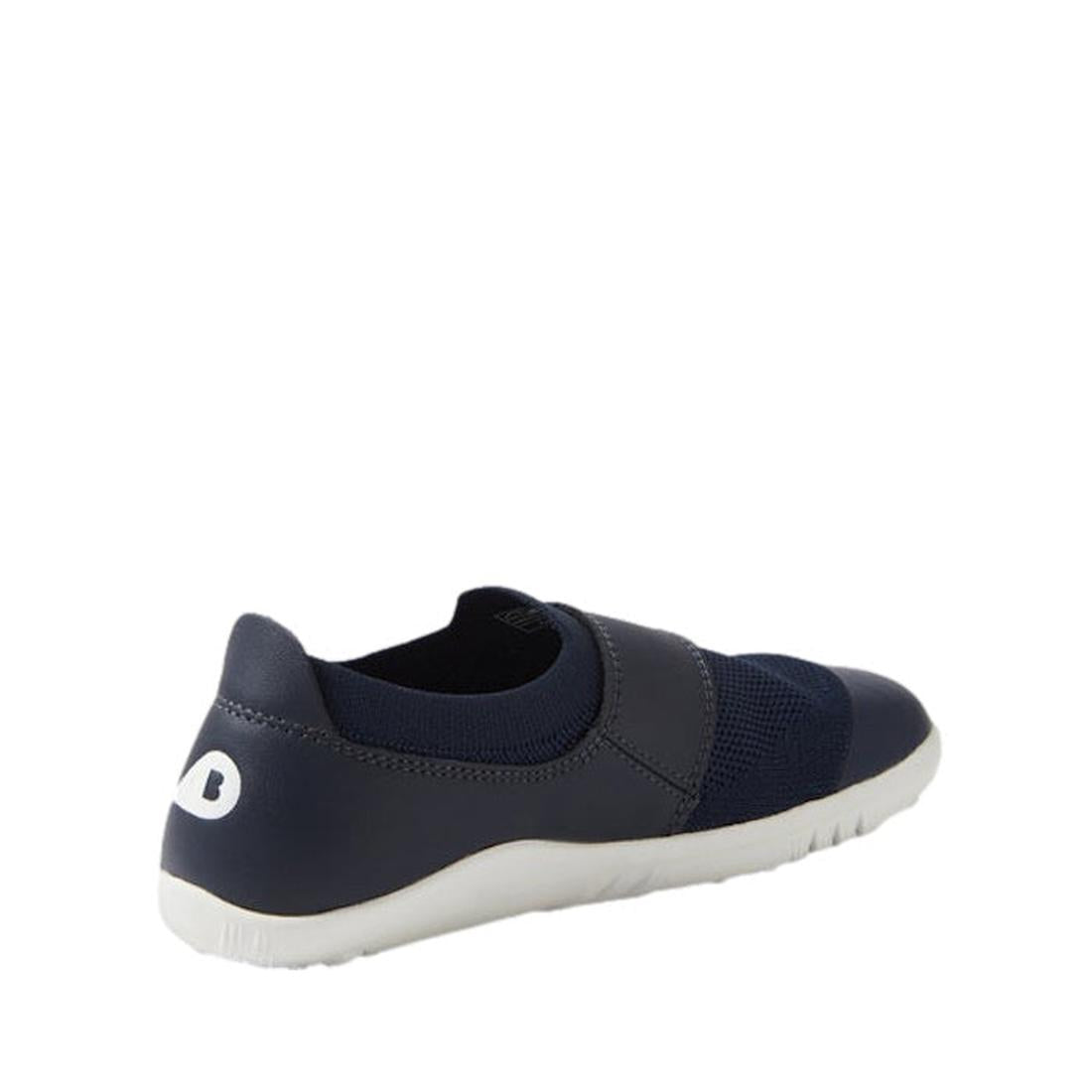 A Bobux Kid+ Lo Dimension III Navy 838610 slip-on athletic shoe with mesh and synthetic materials, white sole, and white heel logo, is shown from a rear side angle against a plain white background., 9420068533202, 9420068533219, 9420068533226, 94200713178
