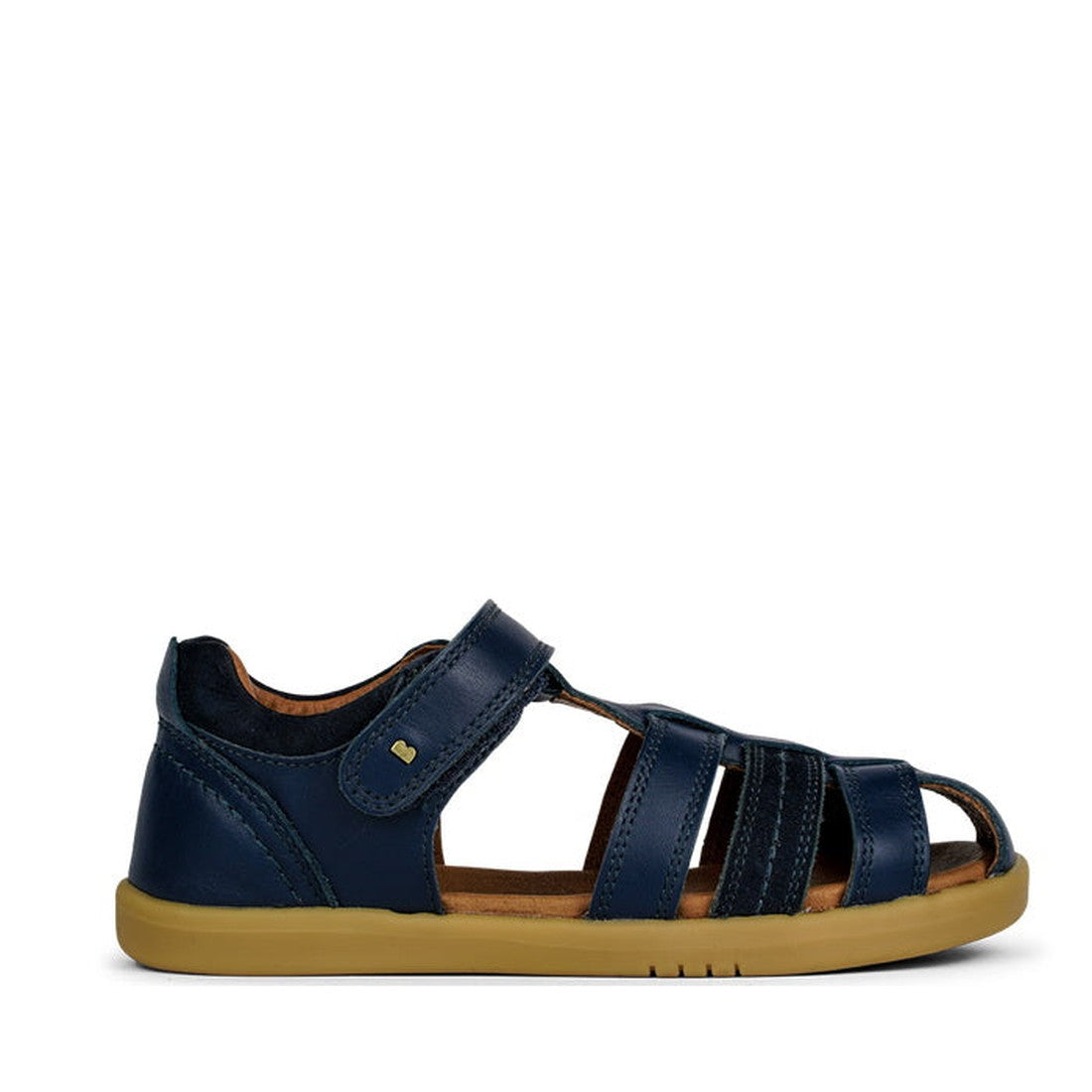 The Bobux Kid+ Plus Roam Navy Closed Toe Sandal 830503A is a stylish navy boys' sandal with leather upper, closed heel, open toe, adjustable Velcro strap, and light brown rubber sole—perfect for active kids. Shown side-on against a white background., 9420