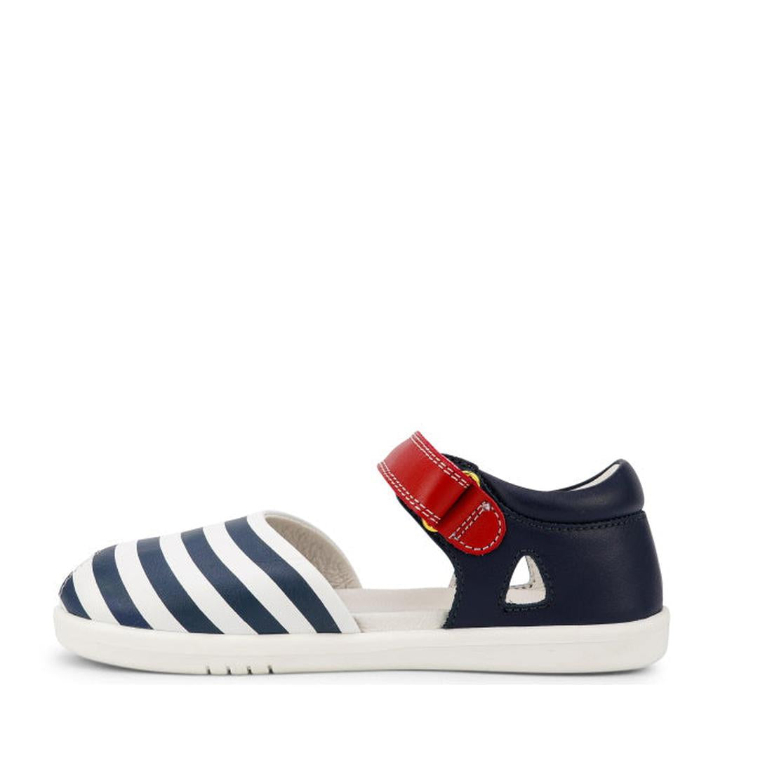 The Bobux Kid + KP Twist Open Toe Sandal Navy features premium leather, navy and white striped front, red Velcro strap, closed back heel support, and a white sole. Displayed in side profile against a white background., 9420068530331, 9420068530348, 942006