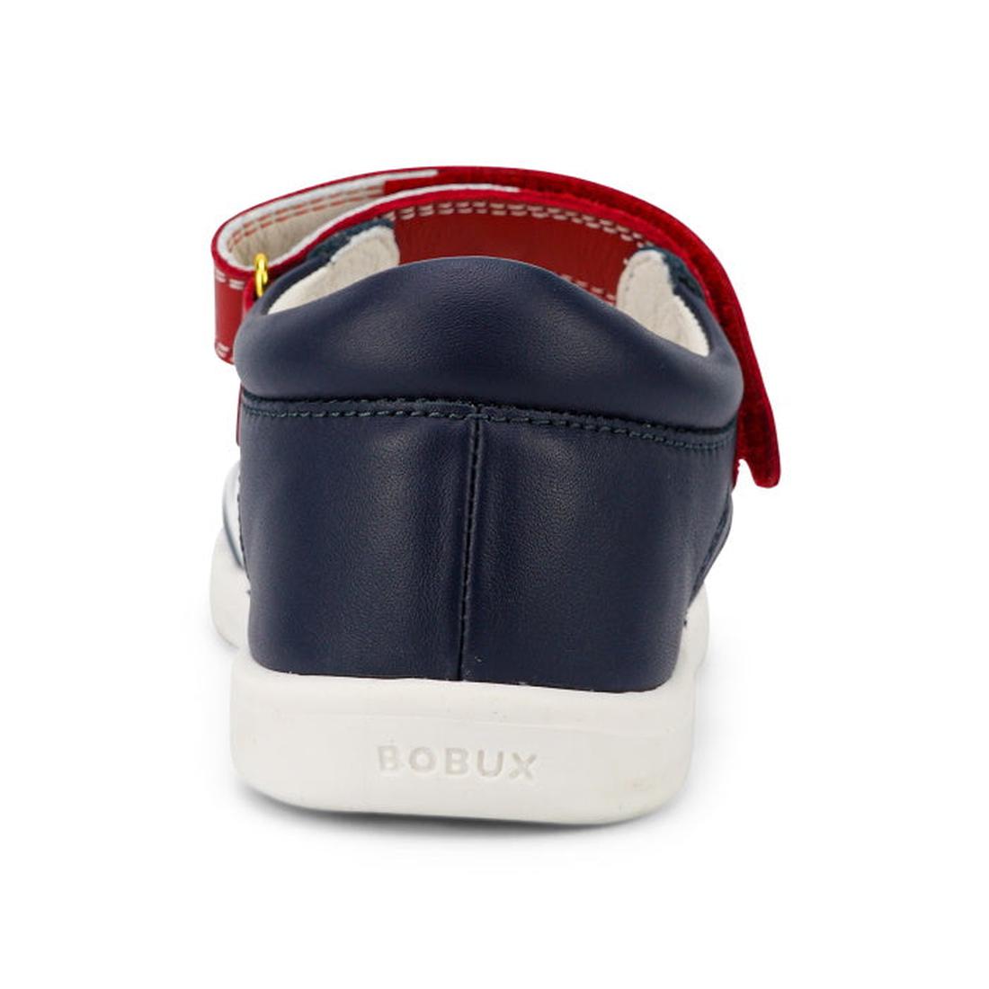 A close-up rear view of the Bobux Kid + KP Twist Open Toe Sandal Navy shows its closed back heel support, white sole, red Velcro strap, and BOBUX embossed on the heel., 9420068530331, 9420068530348, 9420068530355, 9420068530362, 9420068530379, 24131, 2413