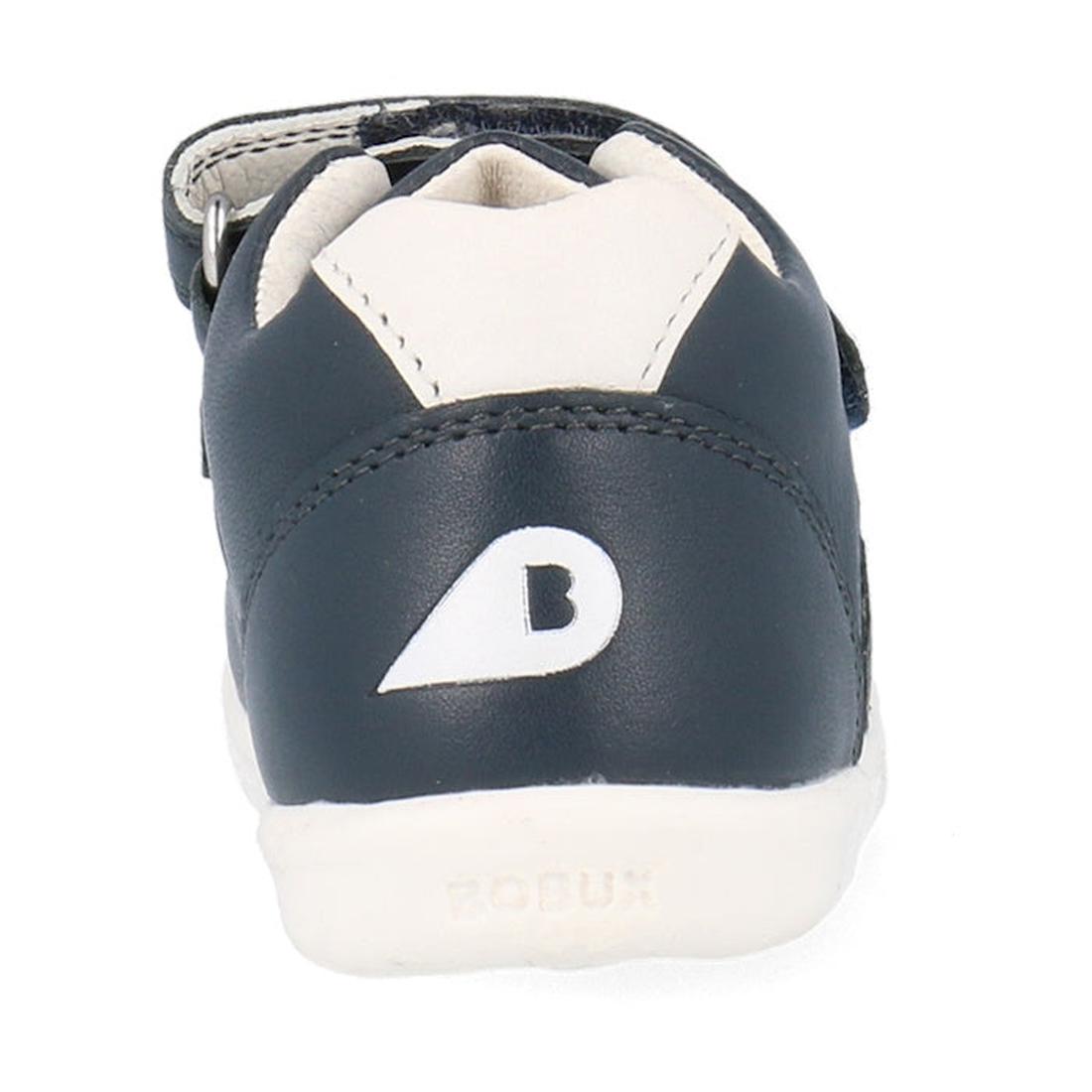 A close-up rear view of the Bobux Kids IWalk IW Comet Sneaker in navy/white, a unisex retro leather kids shoe featuring a B logo on the back and BOBUX embossed on the white sole., 9420075706118, 9420075706125, 9420075706132, 9420075706149, 9420075706156