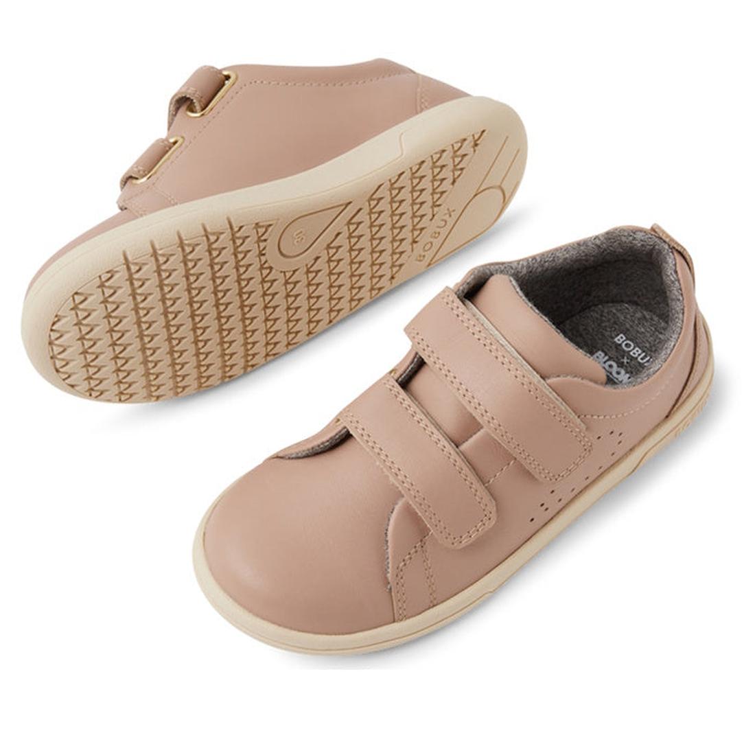 The Bobux KP Kids Plus Grass Court 2 II Leather Sneaker in Warm Taupe features double Velcro straps, rubber soles, a Bloom EVA footbed, and a soft gray lining. One shoe displays the side view; the other highlights the textured sole pattern., 9420074831460
