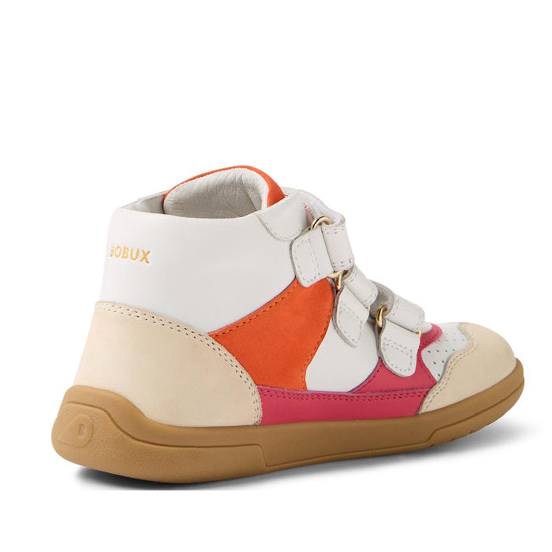The Bobux KP Kids Plus Harley Ankle Leather Boot in Radiant Raspberry for juniors is shown from a side-rear angle, featuring a beige durable sole, white upper, orange and pink panels, gold details, double Velcro straps, and “BOBUX” printed in gold near th