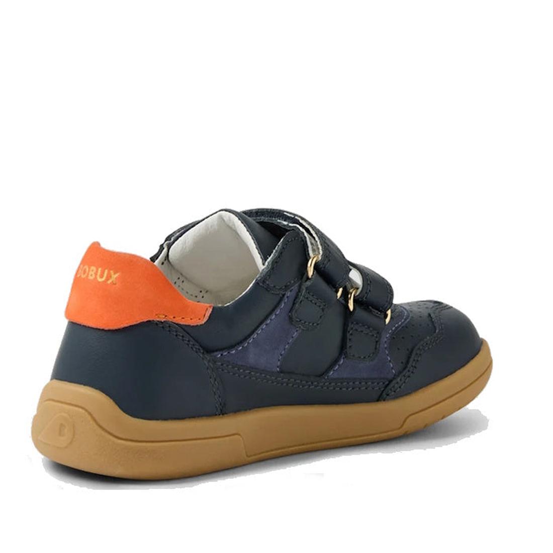 The Bobux KP Kids Plus Hunter Leather Sneaker in Navy for juniors features dark blue Quickdry leather, a tan rubber sole, orange heel accent, and double velcro straps. Shown from the back and side., 9420074834355, 9420074834362, 9420074834379, 94200748343