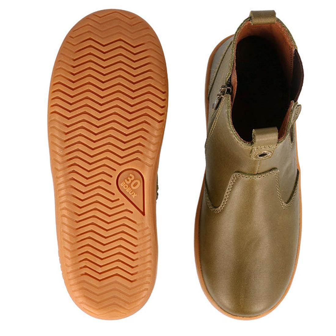 A pair of Bobux Kid+ Jodhpur Boot Olive Toffee 830060: one shows the zigzag-patterned tan sole with a 36 Souk label; the other, seen from above, displays a side zipper. Unisex olive green leather kids boots., 9420075796324, 9420075796270, 9420075796294, 9