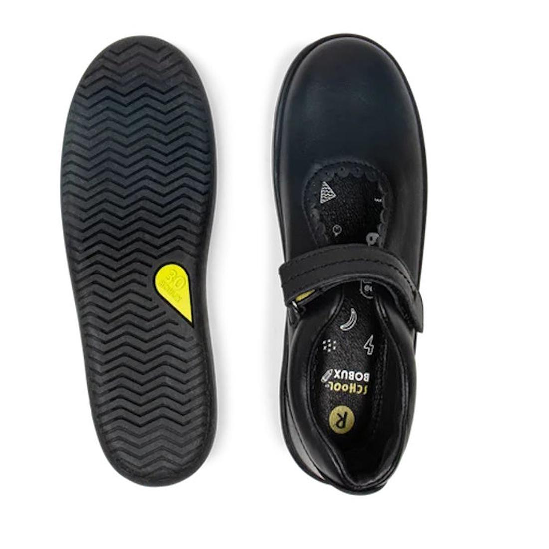 The Bobux Kid+ Black School Leather Shoe Journey Mary Jane is shown in black: one shoe displays a Velcro strap and patterned insole from above, the other reveals a zigzag tread and small yellow label on the sole., 9420068510630, 9420068510647, 94200685106