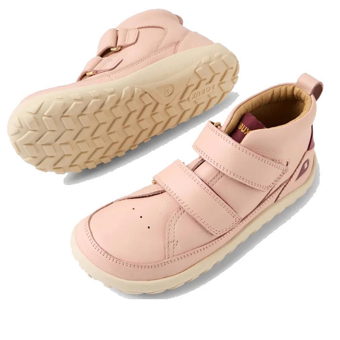 The Bobux KP Kids Plus Trek Leather Boot Juniors in Cameo Rose Pink Alpha features a barefoot-shaped toebox, beige zero-drop soles, two velcro straps, and a heel pull tab, shown from side and bottom views on a white background., 9420068563346, 94200685633