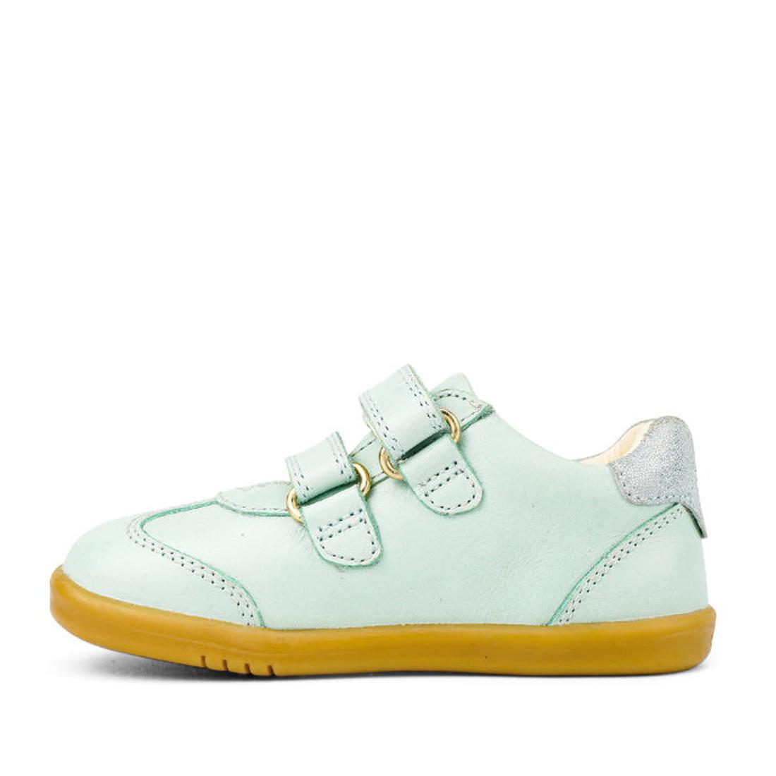 The Bobux Kids IWalk IW Sprite Sneaker in Mist Blue is a unisex shoe featuring double straps, a yellow-brown rubber sole, and a metallic silver heel patch, displayed in side view on a white background., 9420071311095, 9420071311101, 9420071311118, 9420071