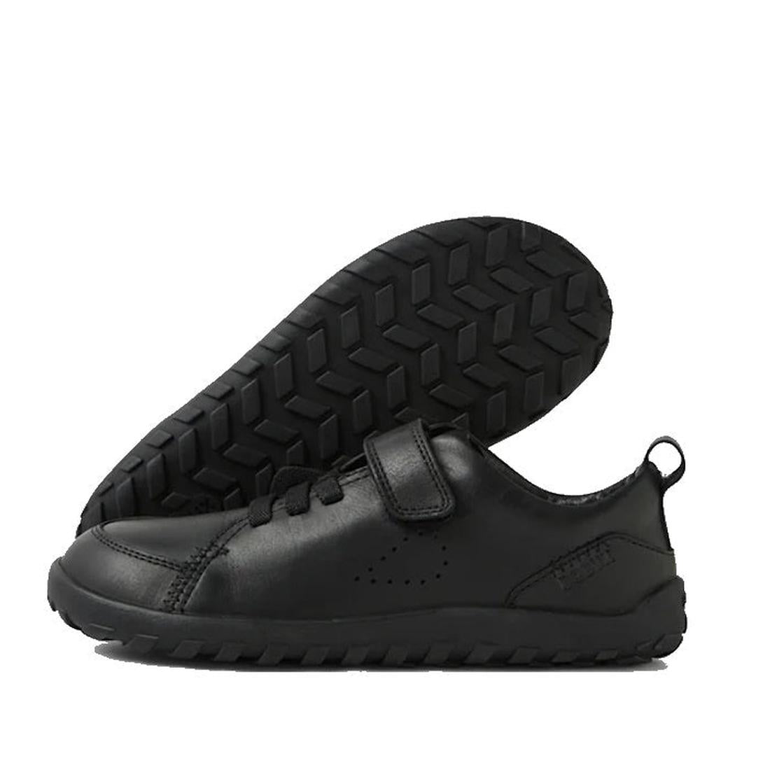 The Bobux Kid+ Prime Alpha Black School Leather Sneaker Shoe for children features a barefoot-shaped toe-box, thick textured rubber soles, Velcro and adjustable straps, and a heel pull tab; one shoe is upright, the other shows its sole., 48416, 9420074804